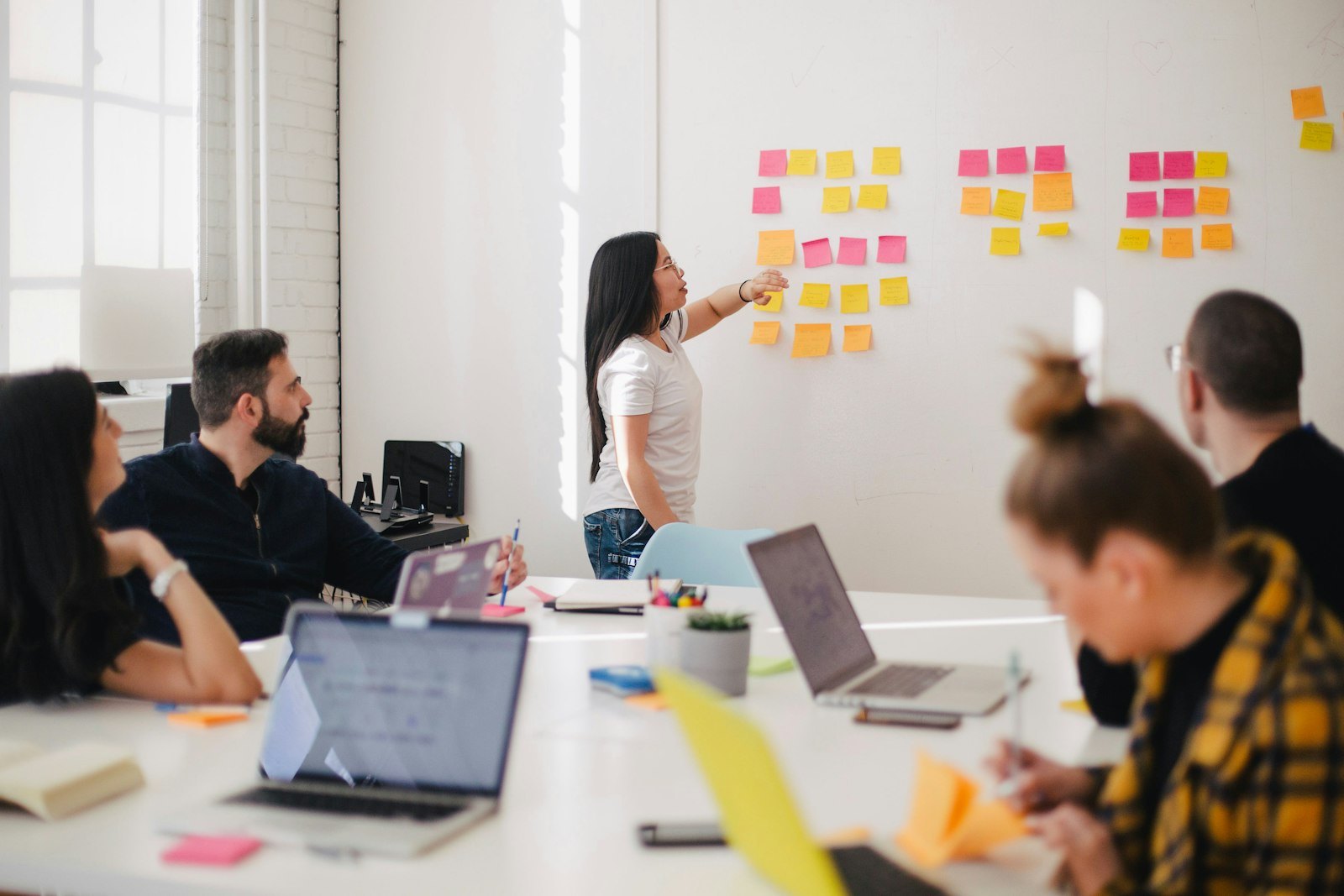 Marketing team reviewing campaign strategy on a large screen in a modern office